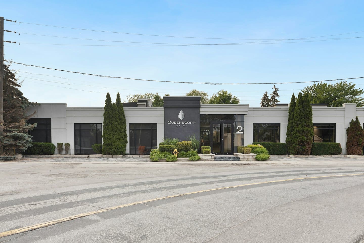 Modern commercial building with large windows and manicured landscaping.