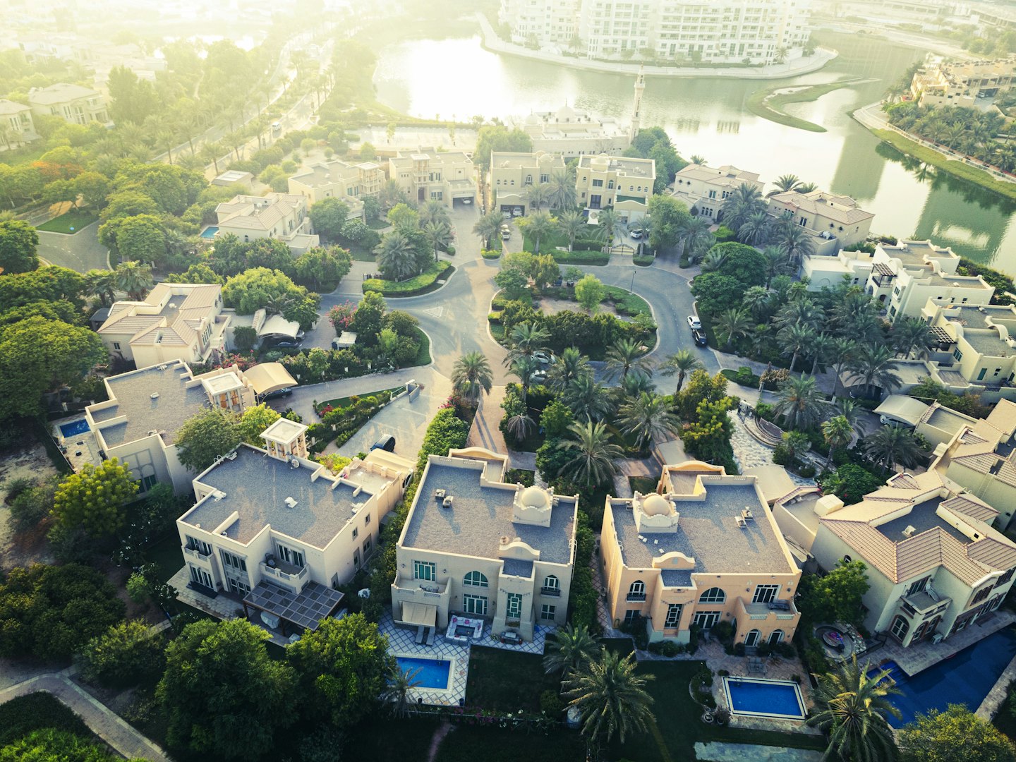 Aerial view of luxury villas with swimming pools and landscaping.